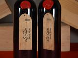 two bottles of wine that are sitting on a table