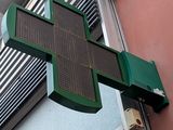 a large green cross on the side of a building