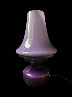 a purple lamp that is sitting on a table