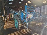a tractor that is parked inside of a barn