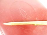 a pen that is laying on top of a red book