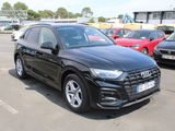 the black audi suv is parked in a parking lot with other cars