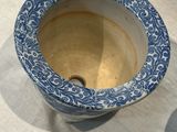 a blue and white vase sitting on a table
