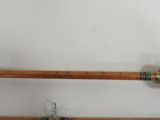 two wooden poles that are holding a pair of scissors