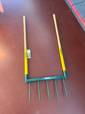a fork and a rake on the floor next to each other