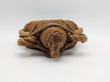 a small stuffed animal that is wrapped in a rope