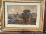 painting of a landscape in a gold frame on a wooden stand