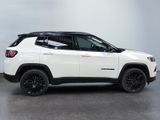 a white jeep compass is parked in a white room
