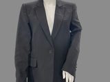 a mannequin dressed in a black suit and white shirt