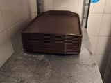 a stack of brown plates sitting on a counter in a kitchen