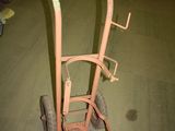 a small cart with a handle in the middle of a room