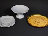 three plates and a bowl sitting on a table