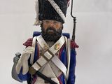 a figurine of a man in a uniform holding a sword