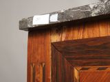 a close up of a marble top on a wooden cabinet