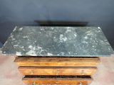 an image of a marble top table with drawers underneath it