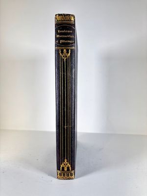 a black and gold book on a white table