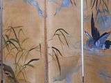 a room divider that has a painting of birds on it