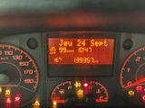 a car dashboard with a digital display showing the speed of the car
