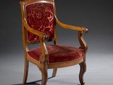 an antique chair with red velvet upholstered seat and wooden frame