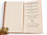 an open book with a baseball glove on top of it