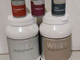 three bottles of whey are sitting next to each other on a counter