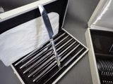 a box with a set of knives in it on a table