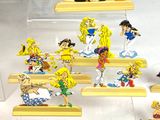 many figurines of cartoon characters displayed in a display case