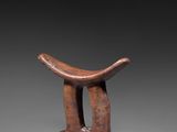 an image of a wooden stool with a curved seat