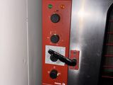 a red machine that is sitting in the corner of a room