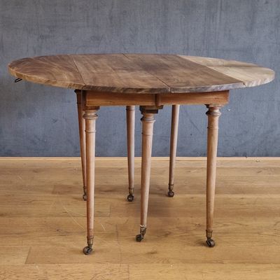 une table en bois munie de roulettes, posée sur un parquet en bois dur