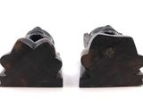 pair of black wood bookends with a carved design