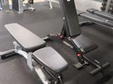 a gym room with a bench, weights, and other equipment