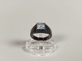 a black ring with a blue stone in it on a clear stand