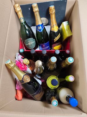 many bottles of wine in a box on the floor