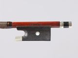 a violin bow with a wooden handle on a white surface