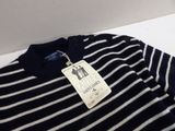 navy blue and white striped sweater with a tag on it
