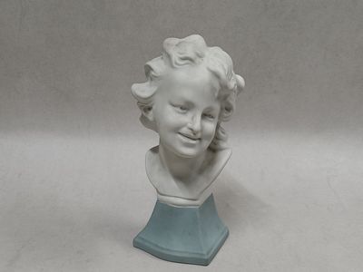 a white bust of a child on a blue base
