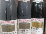 several bottles of wine are lined up on a shelf