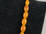 a necklace made out of carnel beads on a mannequin