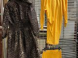 a rack with clothes and a coat on it in a store