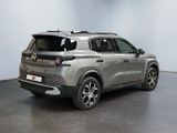 the rear view of a silver suv parked in a garage