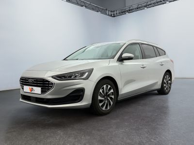une voiture blanche garée dans une pièce blanche au sol noir