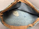 a close up of a blue hat with a brown band