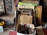 a pile of books on a table next to a chair