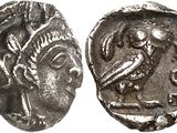a silver coin with an image of a woman and a bird on it