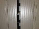 an image of a closet with a sliding door in a garage