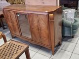 a wooden cabinet with a glass door in the middle of a room
