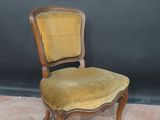 an old wooden chair with a yellow upholstered seat