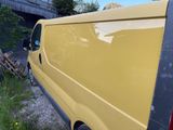 a yellow van parked in front of a building