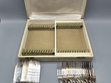 a box with silverware in it on a table